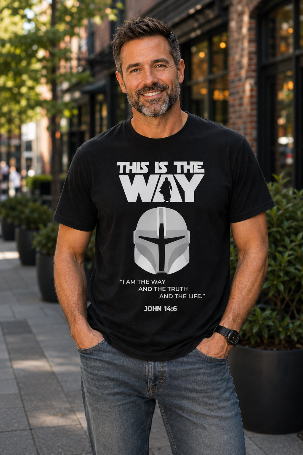 Man wearing a black This Is the Way Christian graphic T-shirt featuring a Mandalorian-inspired helmet and John 14:6 design
