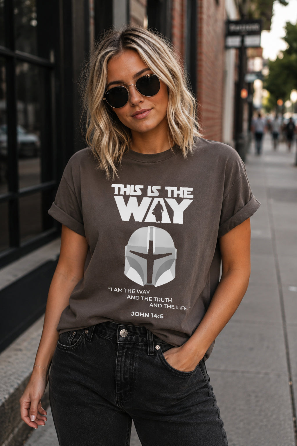 Woman wearing a pepper gray This Is the Way Christian graphic T-shirt featuring a Mandalorian-inspired helmet and John 14:6 design