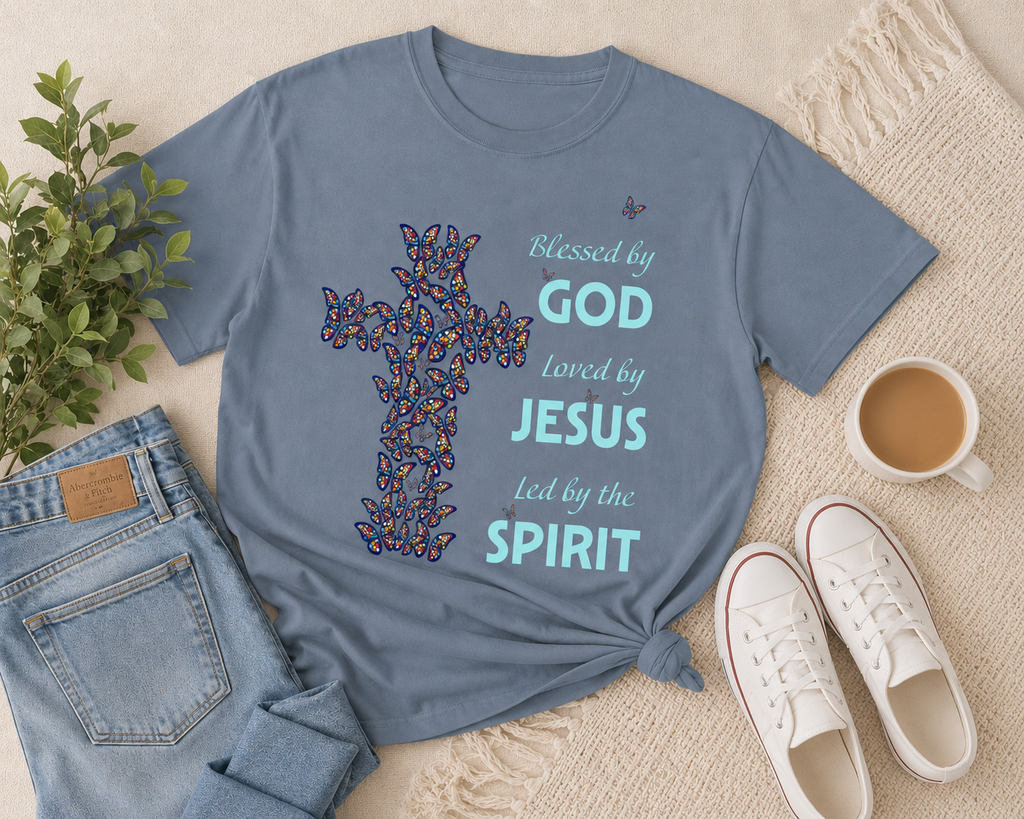 Pepper blue Christian butterfly cross t-shirt flat lay with light denim jeans, neutral sneakers, greenery, and soft beige lifestyle styling