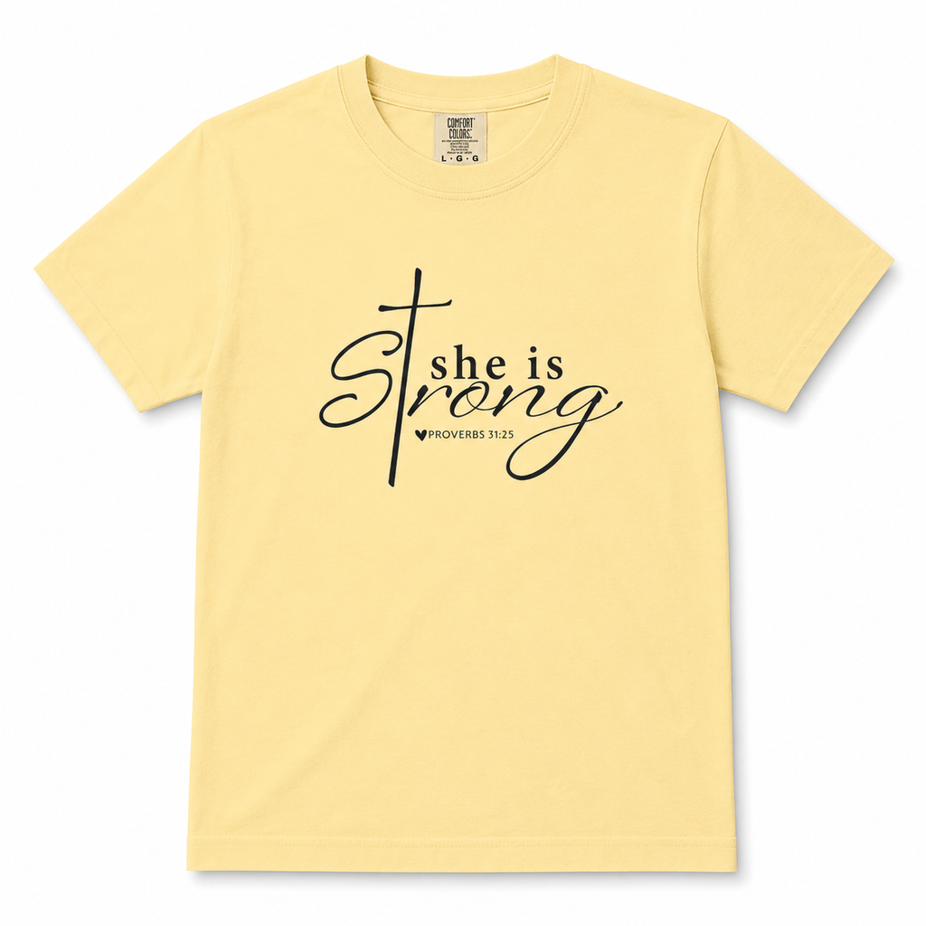 Youth Christian t-shirt in butter yellow featuring “She is Strong” with Proverbs 31:25 in black script lettering.
